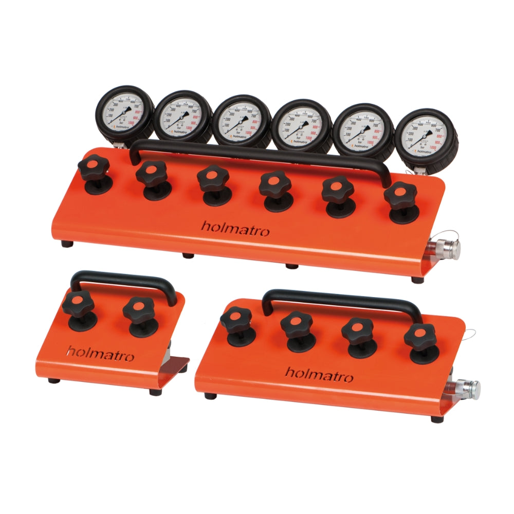 Orange Holmatro manifolds med manometre og kontrolknapper i forskellige størrelser.